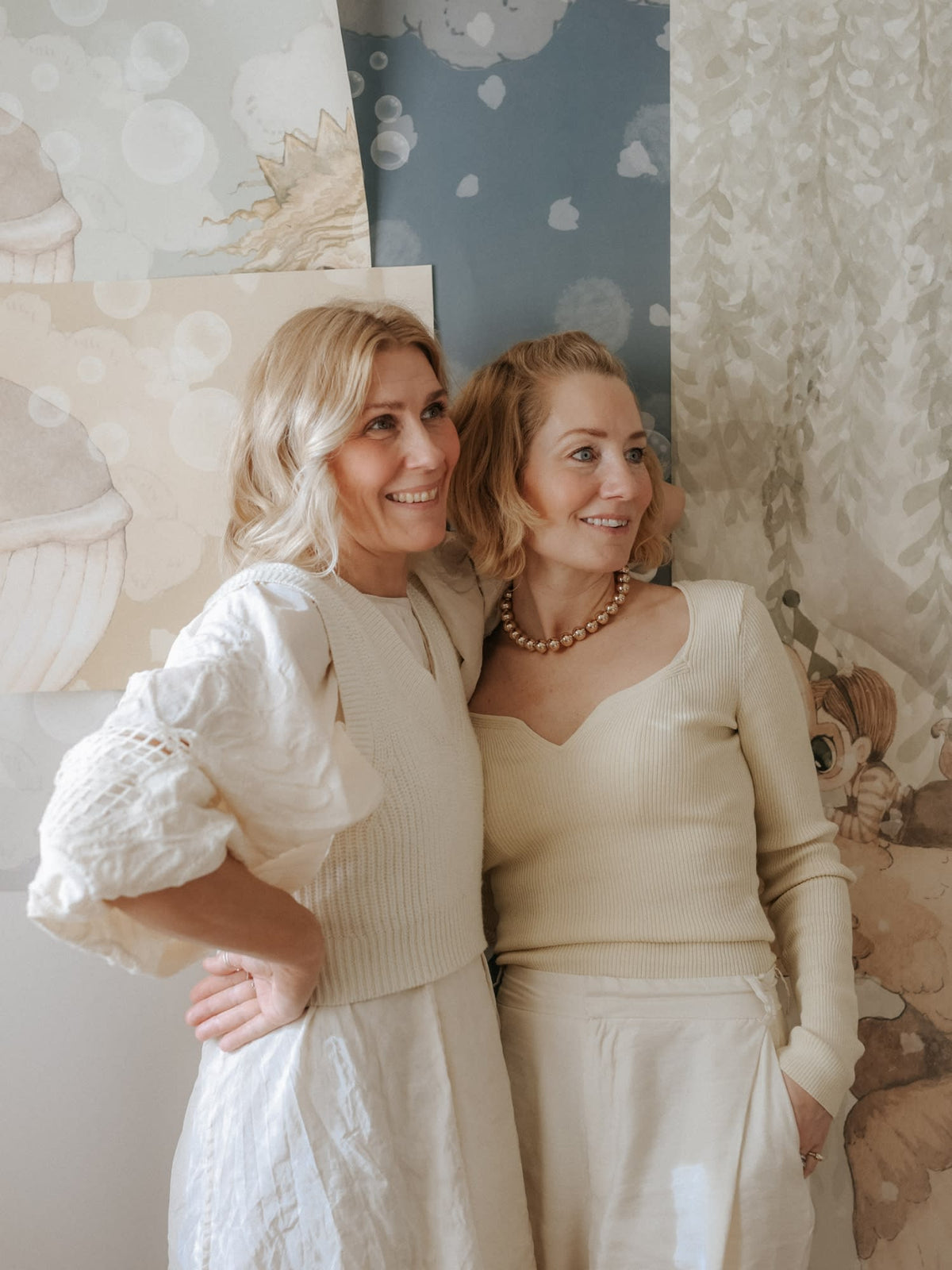 The two designers behind Mrs Mighetto, photographed with their Rebel Walls wallpapers