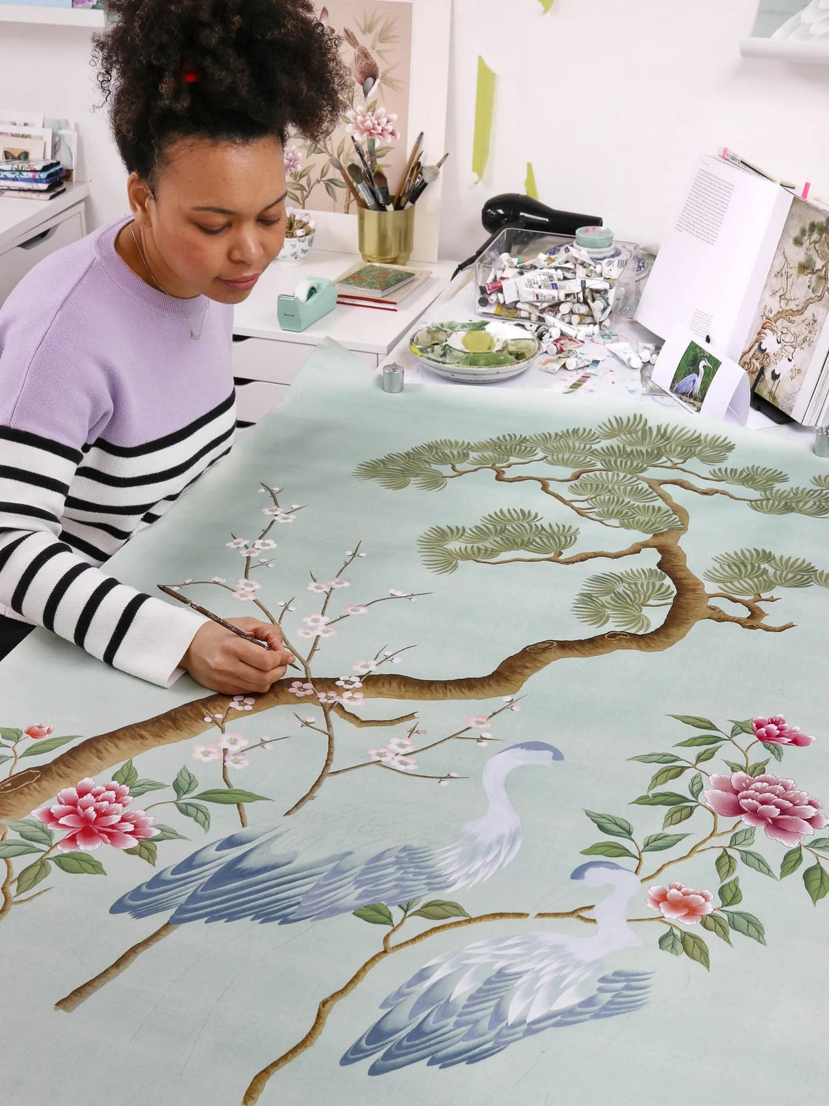 Diane Hill painting chinoiserie by hand in her London studio, for her Rebel Walls collection