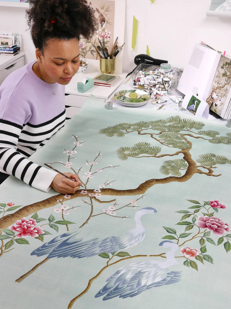 Diane Hill painting chinoiserie by hand in her London studio, for her Rebel Walls collection