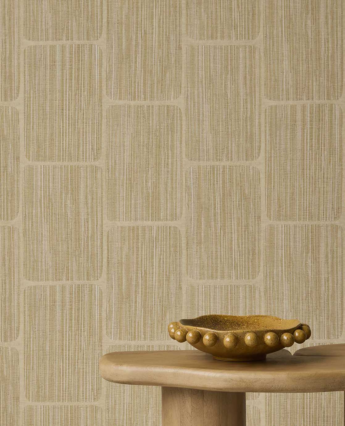 Woven Grid wallpaper in straw yellow behind a timber side table and bowl