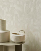 Pebble Relief wallpaper in light green behind white ceramic vases
