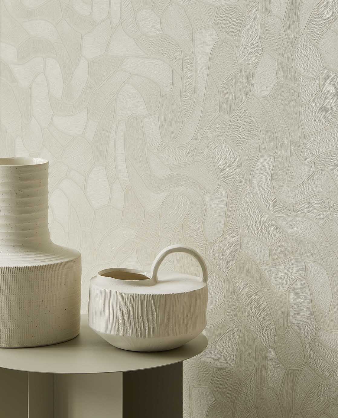 Pebble Relief wallpaper in light green behind white ceramic vases