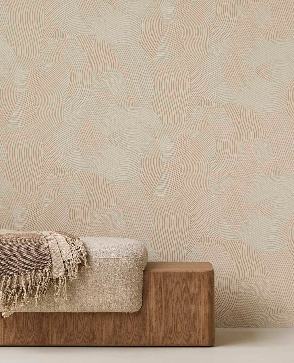 Raked Sand wallpaper in beige behind a timber bench with a throw