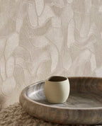 Pebble Relief wallpaper in beige, close-up behind a timber bowl