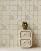 Looping Line wallpaper in green with gold lines behind a white bedside cabinet