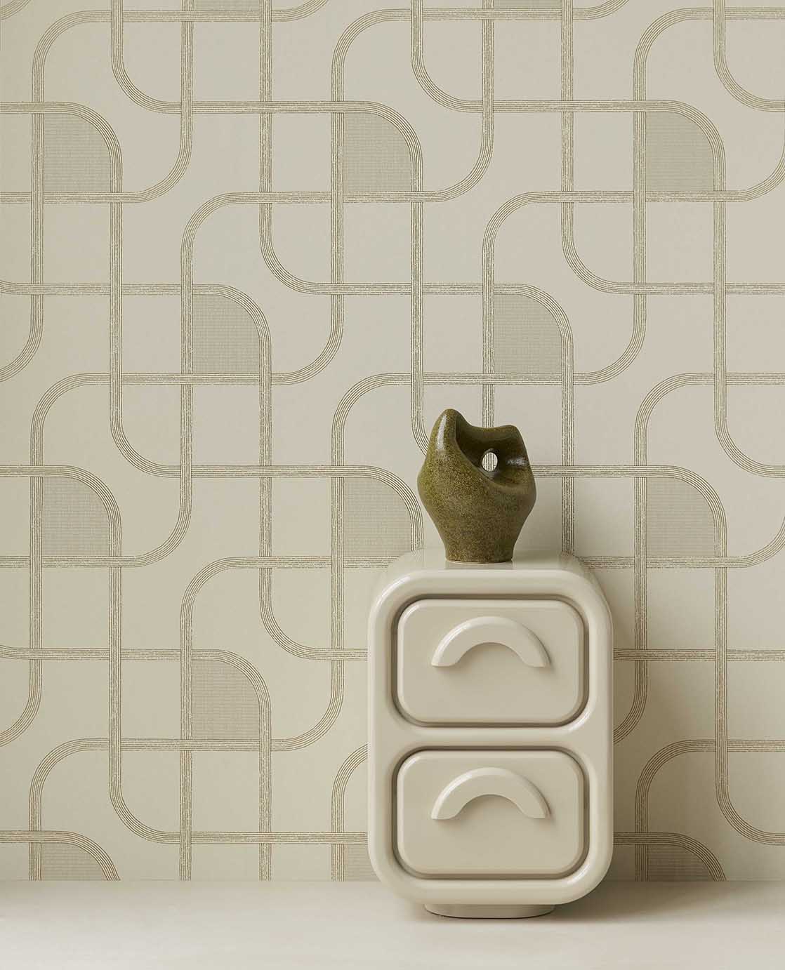 Looping Line wallpaper in green with gold lines behind a white bedside cabinet