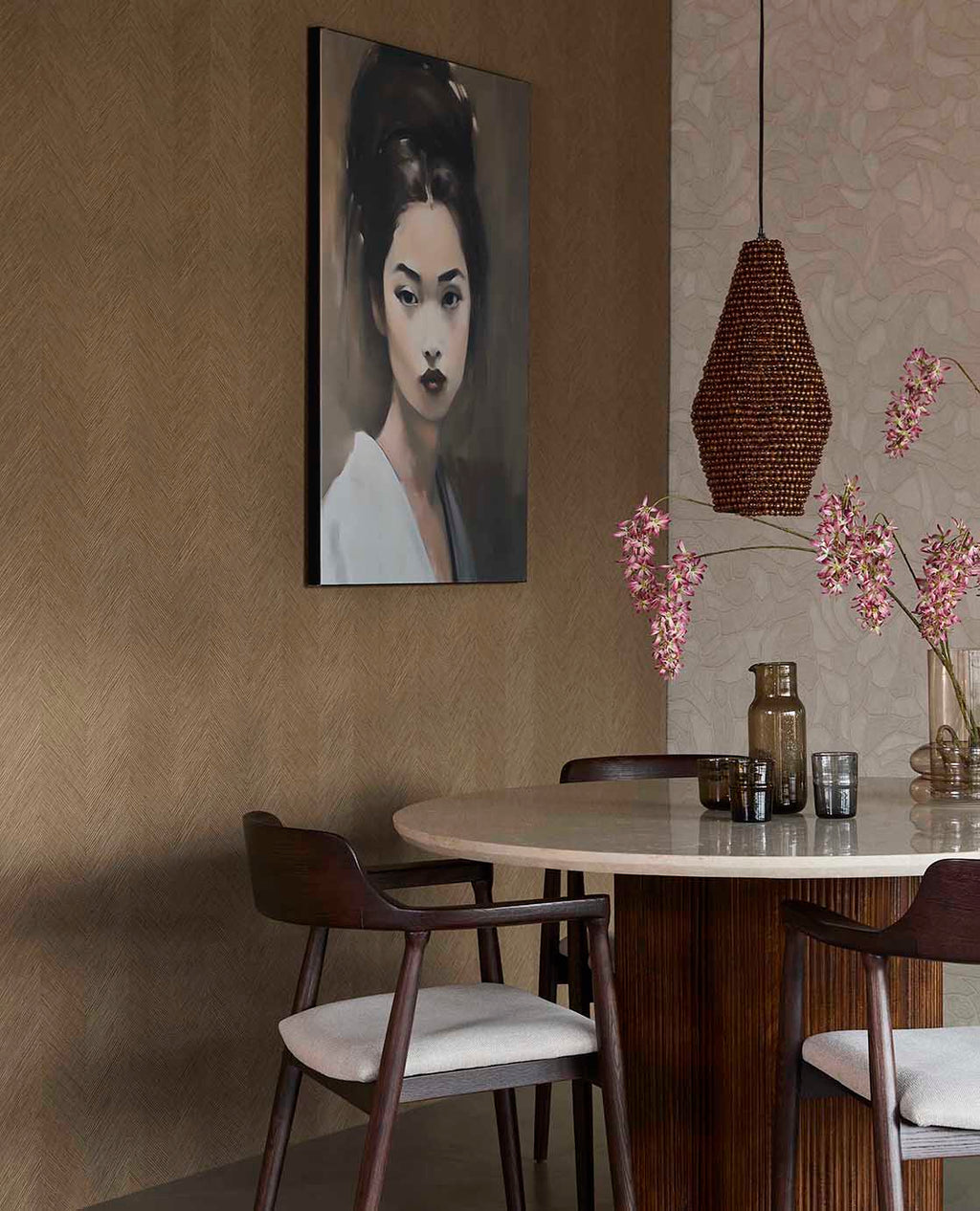 Woven Herringbone wallpaper in taupe in a dining room with a round table and rattan pendant