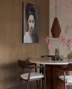 Woven Herringbone wallpaper in taupe in a dining room with a round table and rattan pendant