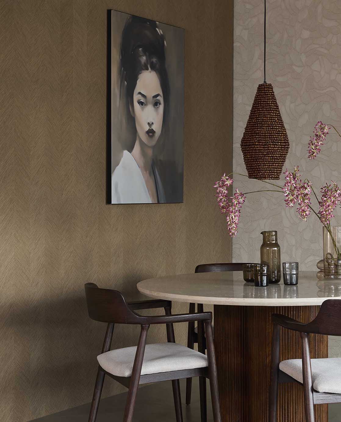 Woven Herringbone wallpaper in taupe in a dining room with a round table and rattan pendant