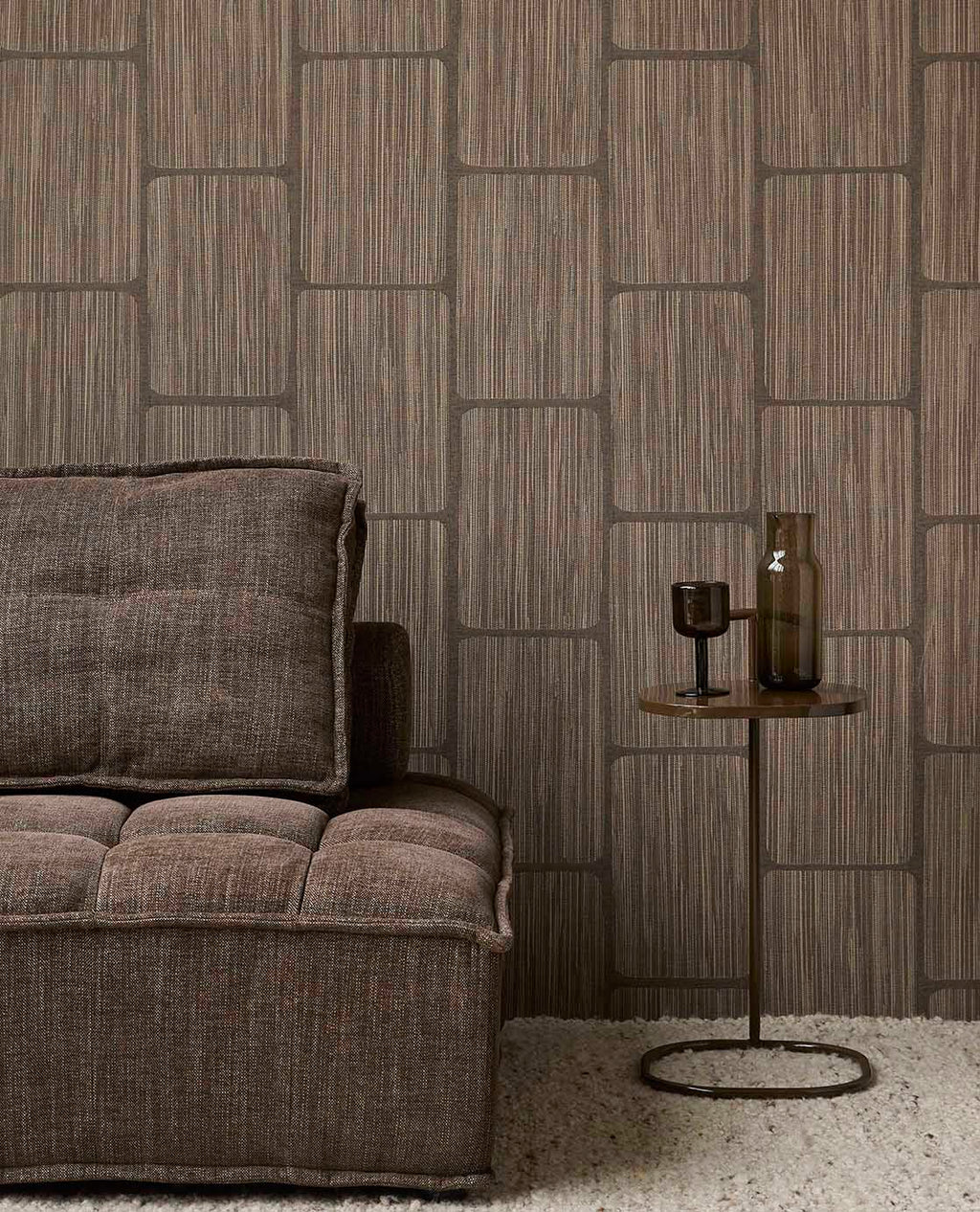 Woven Grid wallpaper in dark brown behind a brown sofa and side table