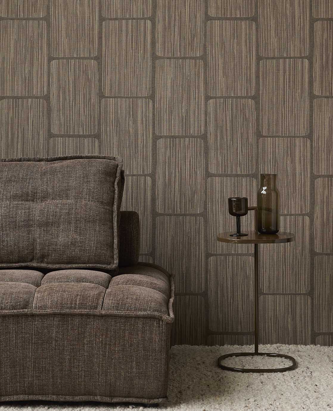 Woven Grid wallpaper in dark brown behind a brown sofa and side table