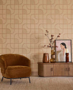 Looping Line wallpaper in peach with copper lines in a living room with an ochre armchair and sideboard