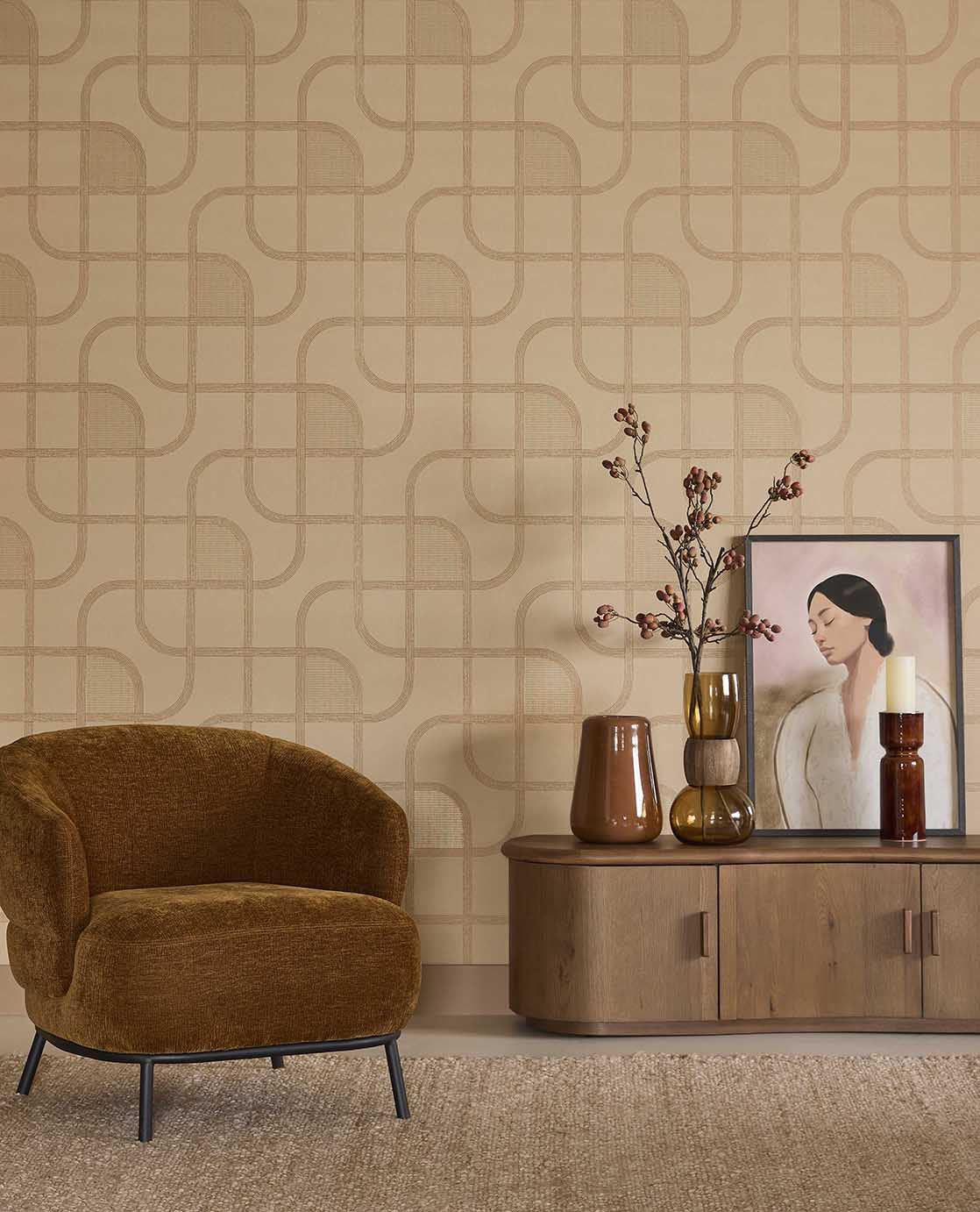 Looping Line wallpaper in peach with copper lines in a living room with an ochre armchair and sideboard