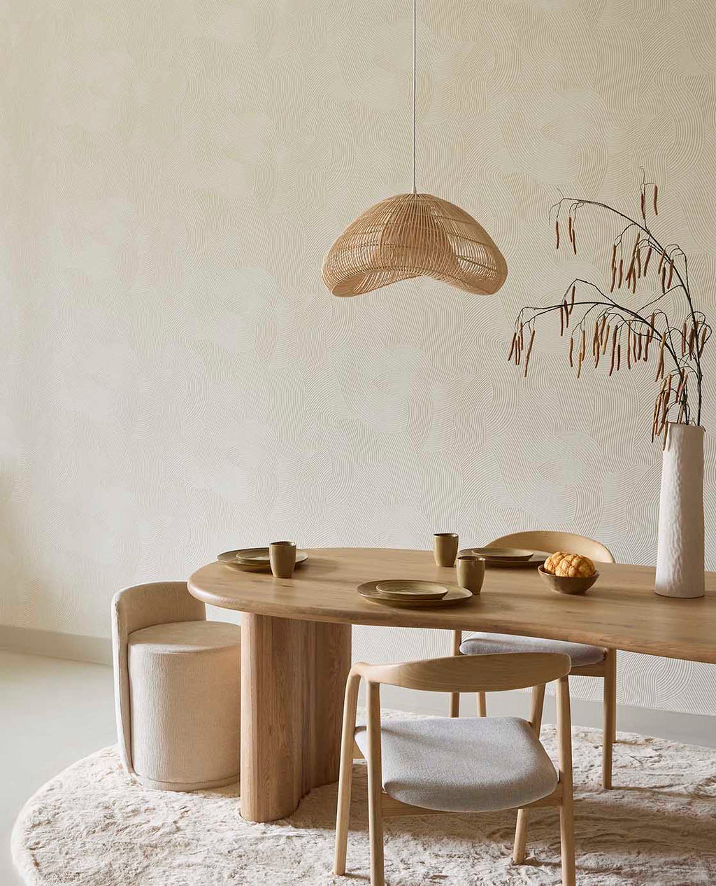 Raked Sand wallpaper in cream in a dining room with a round timber table and rattan pendant