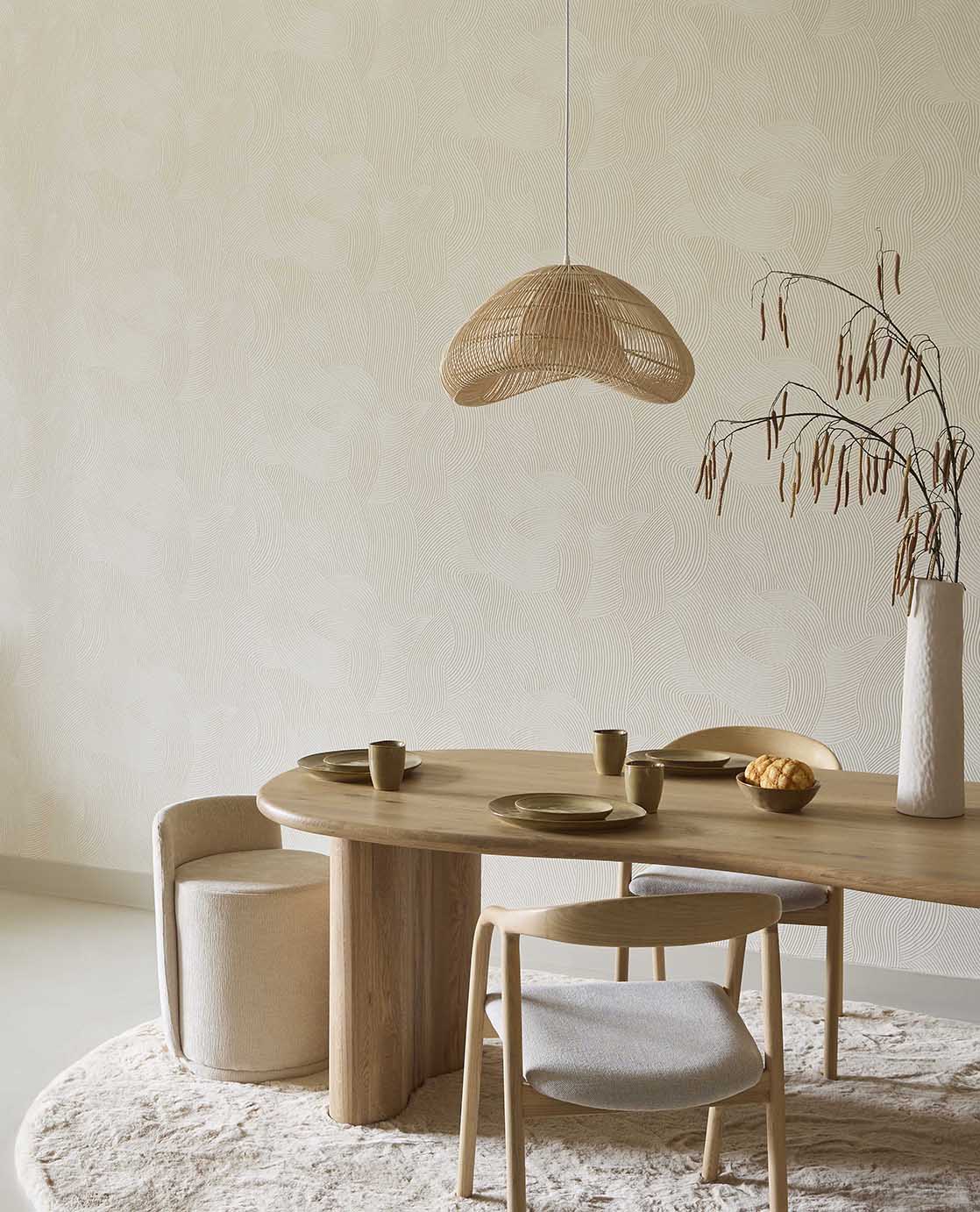 Raked Sand wallpaper in cream in a dining room with a round timber table and rattan pendant