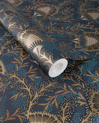 Banksia Bloom wallpaper by Eijffinger in dark teal navy with copper-gold floral motif, shown on a partially unrolled roll