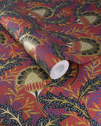 Banksia Bloom wallpaper by Eijffinger in terracotta red with navy and gold floral motif, shown on a partially unrolled roll