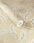 Banksia Bloom wallpaper by Eijffinger, cream and soft gold thistle floral motif shown on a partially unrolled swatch