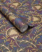Banksia Bloom wallpaper by Eijffinger in plum purple with golden thistle blooms and blue dots, shown on a curled swatch