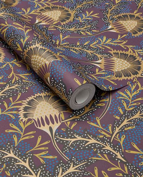 Banksia Bloom wallpaper by Eijffinger in plum purple with golden thistle blooms and blue dots, shown on a curled swatch