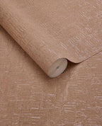 Bark Wash wallpaper by Eijffinger, rolled swatch in warm terracotta tan with a metallic bark-effect crackle texture