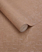 Bark Wash wallpaper by Eijffinger, rolled swatch in warm terracotta tan with a metallic bark-effect crackle texture