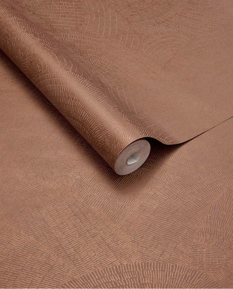 Scallop Fan wallpaper by Eijffinger, rolled swatch in warm terracotta copper showing the overlapping scallop fan motif