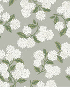 Hydrangea Bloom wallpaper by Eijffinger, white hydrangeas with green leaves on soft grey, flat swatch.