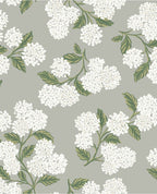 Hydrangea Bloom wallpaper by Eijffinger, white hydrangeas with green leaves on soft grey, flat swatch.
