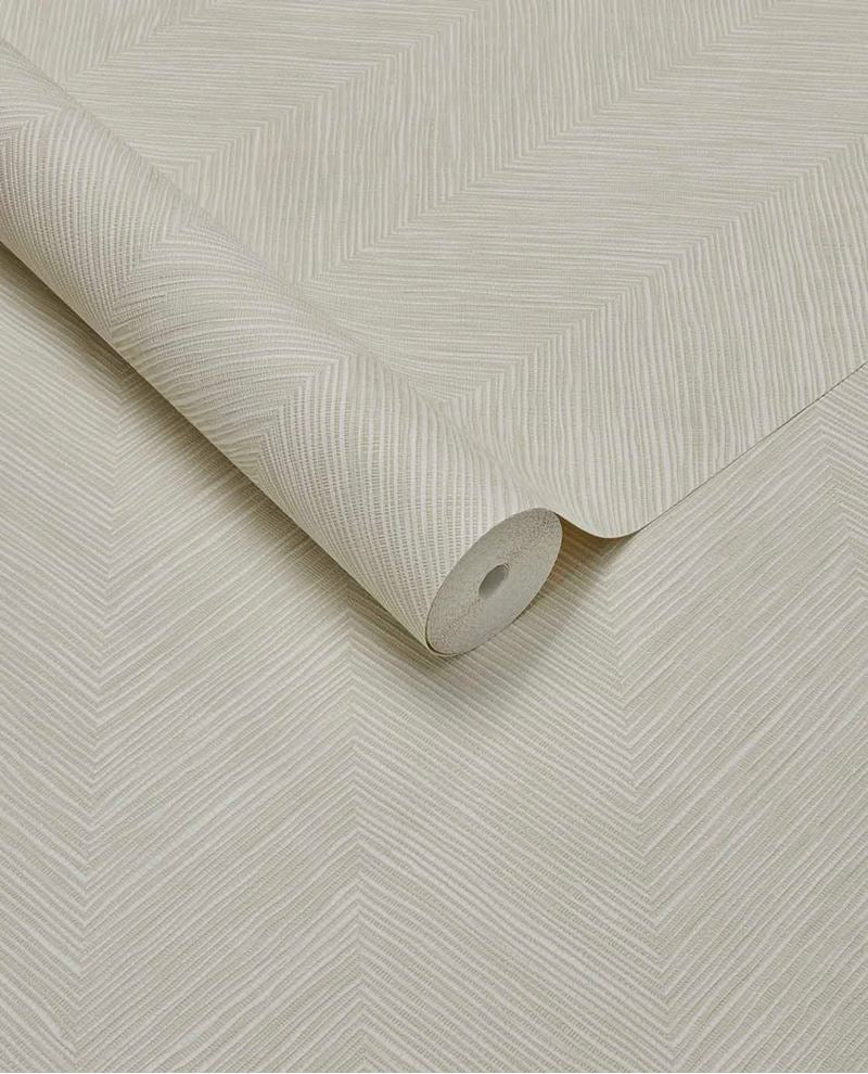 Woven Herringbone wallpaper by Eijffinger in soft cream, linen-look herringbone texture on a partly unrolled roll