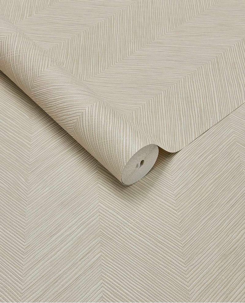 Woven Herringbone wallpaper by Eijffinger in light beige, woven chevron texture on a partly unrolled roll