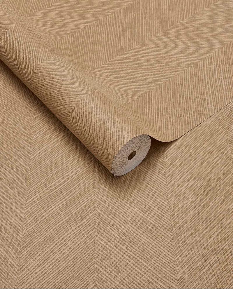 Woven Herringbone wallpaper by Eijffinger in honey tan, textured chevron weave on a partly unrolled roll