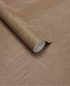 Woven Herringbone wallpaper by Eijffinger in warm taupe, linen-look chevron weave on a partly unrolled roll