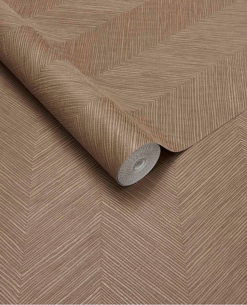 Woven Herringbone wallpaper by Eijffinger in warm taupe, linen-look chevron weave on a partly unrolled roll