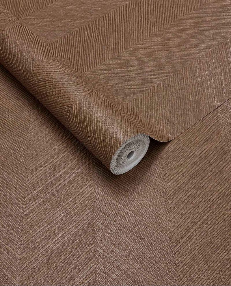 Woven Herringbone wallpaper by Eijffinger in russet brown, textured herringbone weave shown as an unrolled roll