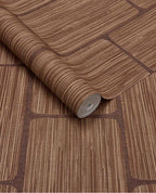 Woven Grid wallpaper by Eijffinger in rich rust brown, grasscloth weave with grid panel outlines, rolled product shot