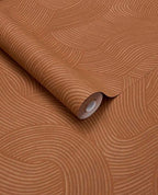Raked Sand wallpaper by Eijffinger in terracotta rust, raked-sand combed wave relief texture, rolled product shot