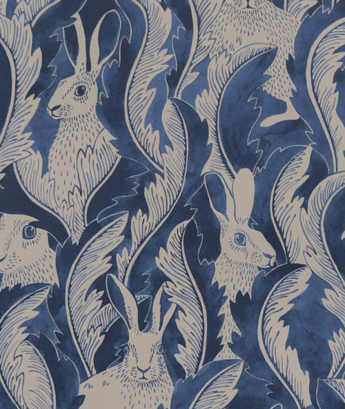 Close-up of Hiding Hares wallpaper by Emma von Brömssen in Dark Denim, cream hares hidden among navy painted foliage