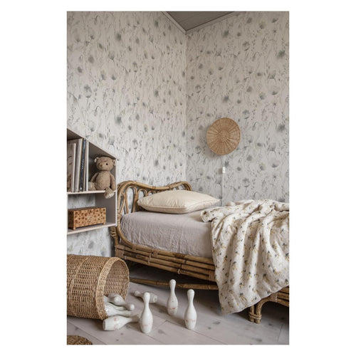 Grey watercolour Lo floral wallpaper by Sandberg in a childs bedroom with rattan daybed and teddy