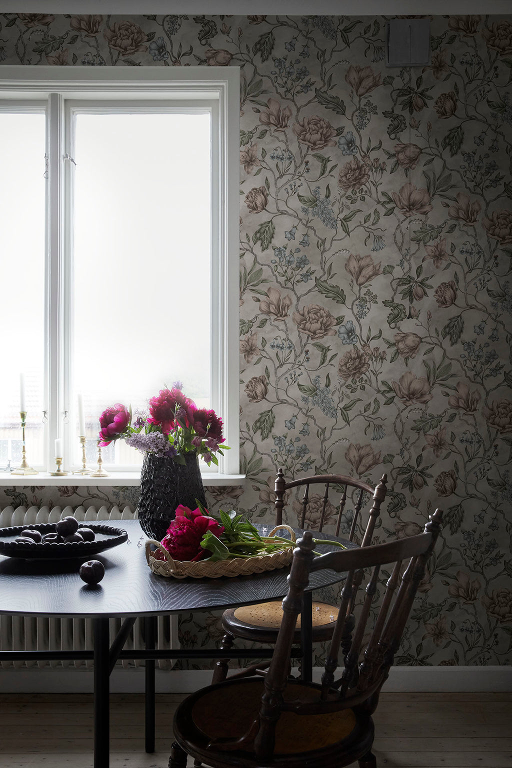 Linda wallpaper by Sandberg in soft greige in a dining nook by a window with peonies on a dark table