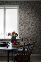 Linda wallpaper by Sandberg in soft greige in a dining nook by a window with peonies on a dark table