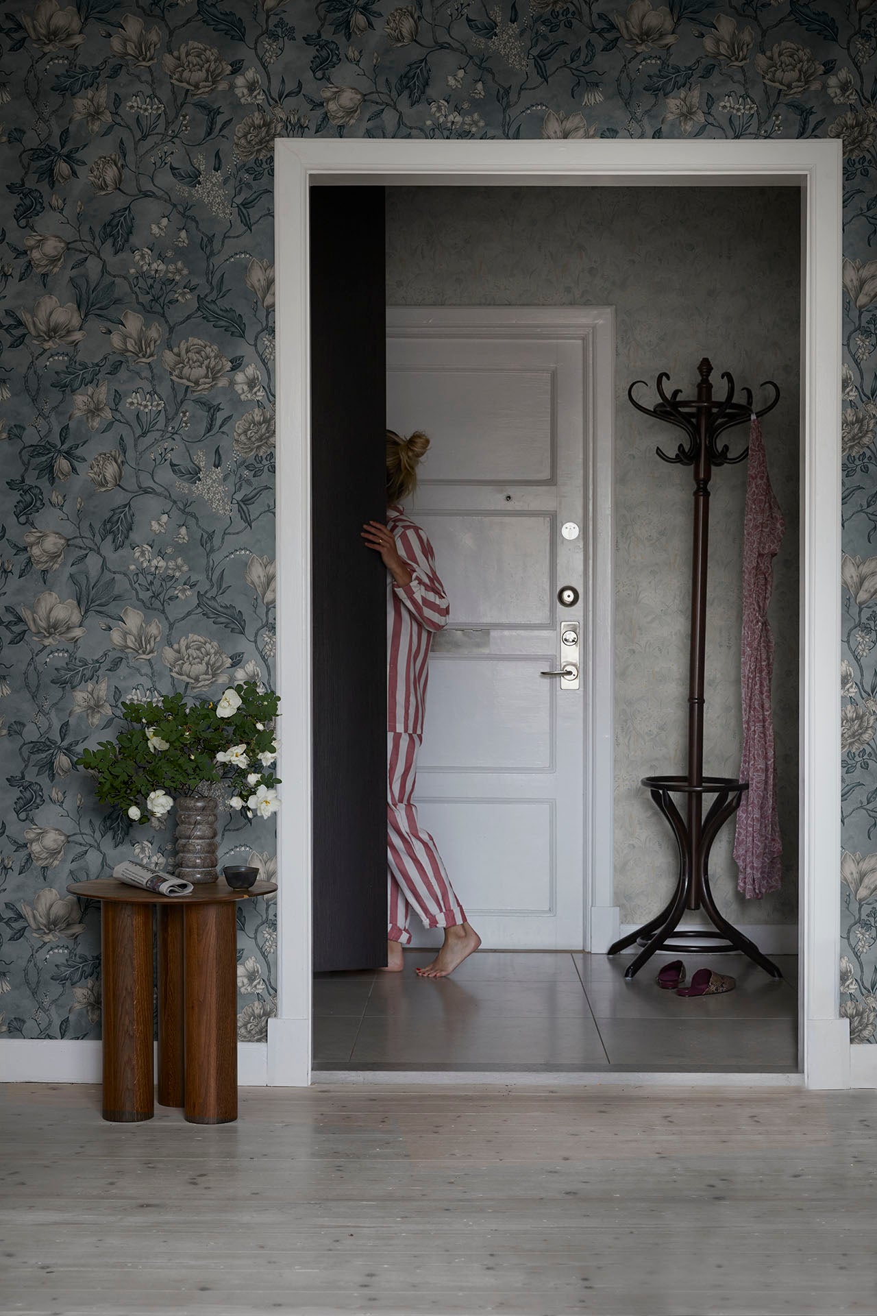 Linda wallpaper by Sandberg in Misty Blue, styled on an interior wall