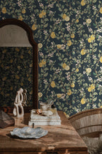 Kvitten wallpaper by Sandberg, navy quince-branch design styled behind a wooden dressing table with an arched mirror