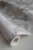 Raphael wallpaper by Sandberg, close-up of a part-rolled roll in soft grey oak-tree print