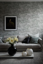 Raphael wallpaper by Sandberg in grey oak-tree print in a living room with a linen sofa and framed artwork