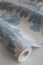 Raphael wallpaper by Sandberg, close-up of a part-rolled roll in blue oak-tree print on cream