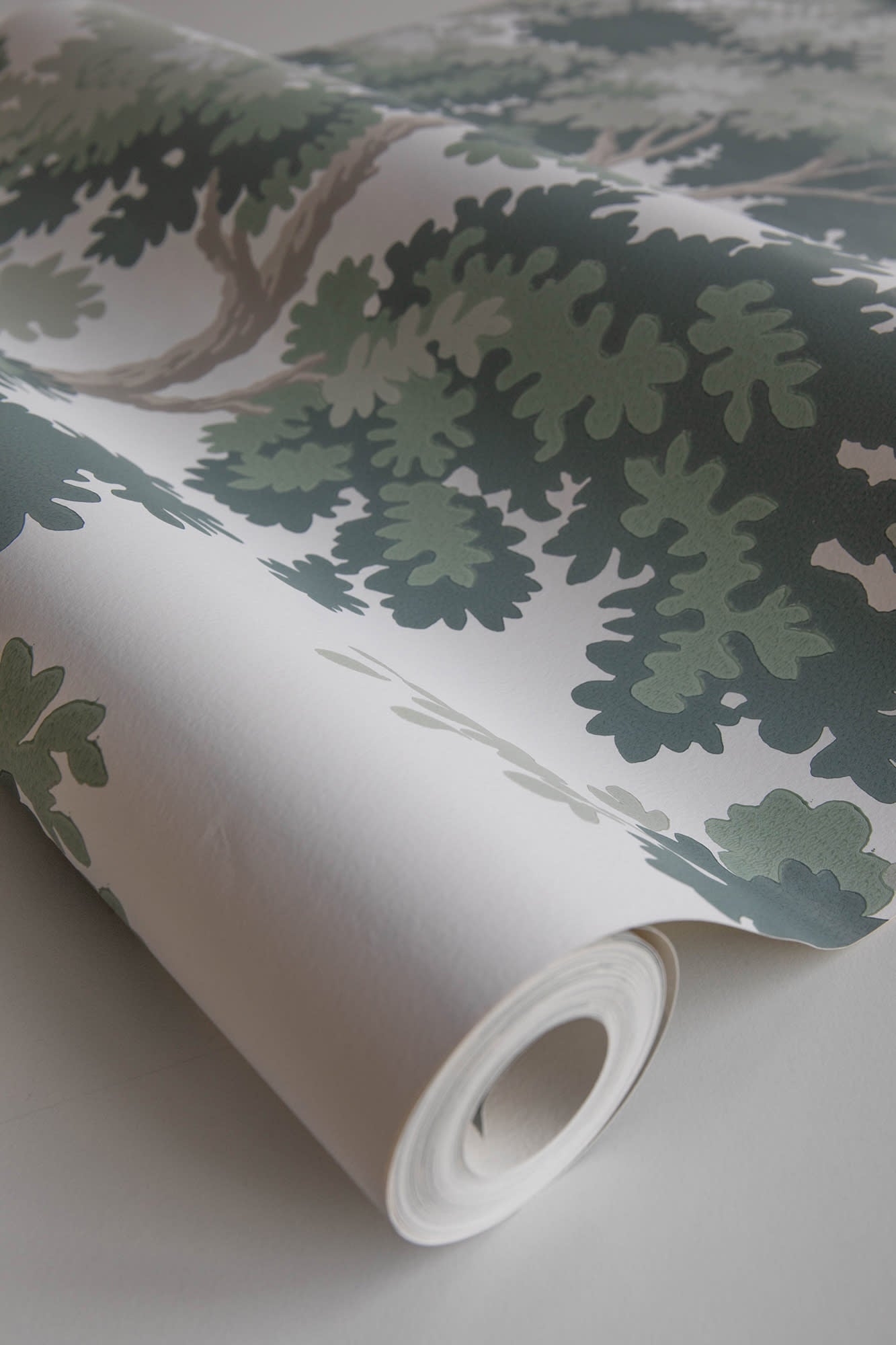 Raphael wallpaper by Sandberg in Green, part-unrolled length showing the painterly oak-leaf print up close