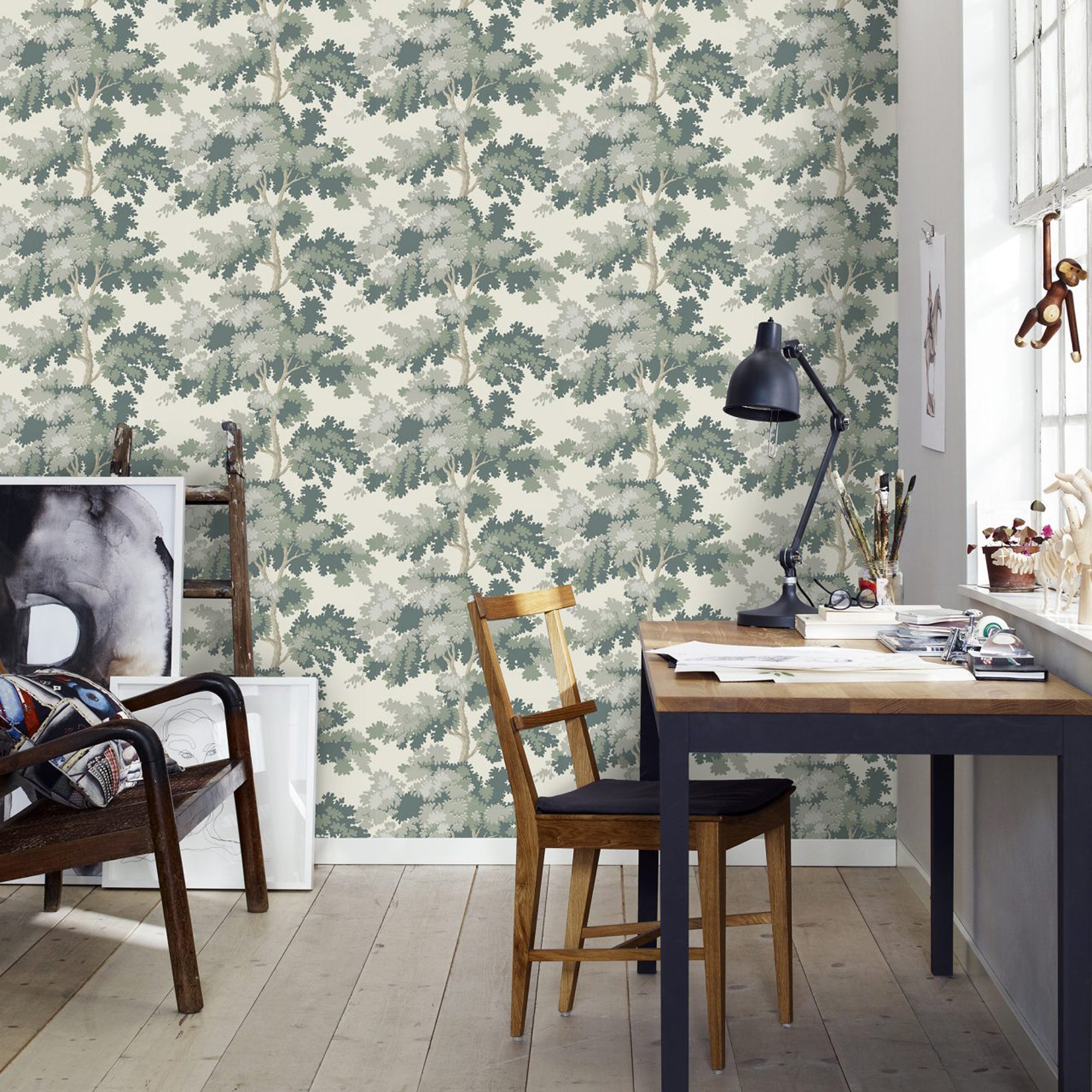Raphael wallpaper by Sandberg in Green in a home office with a navy desk, wooden chair and black task lamp