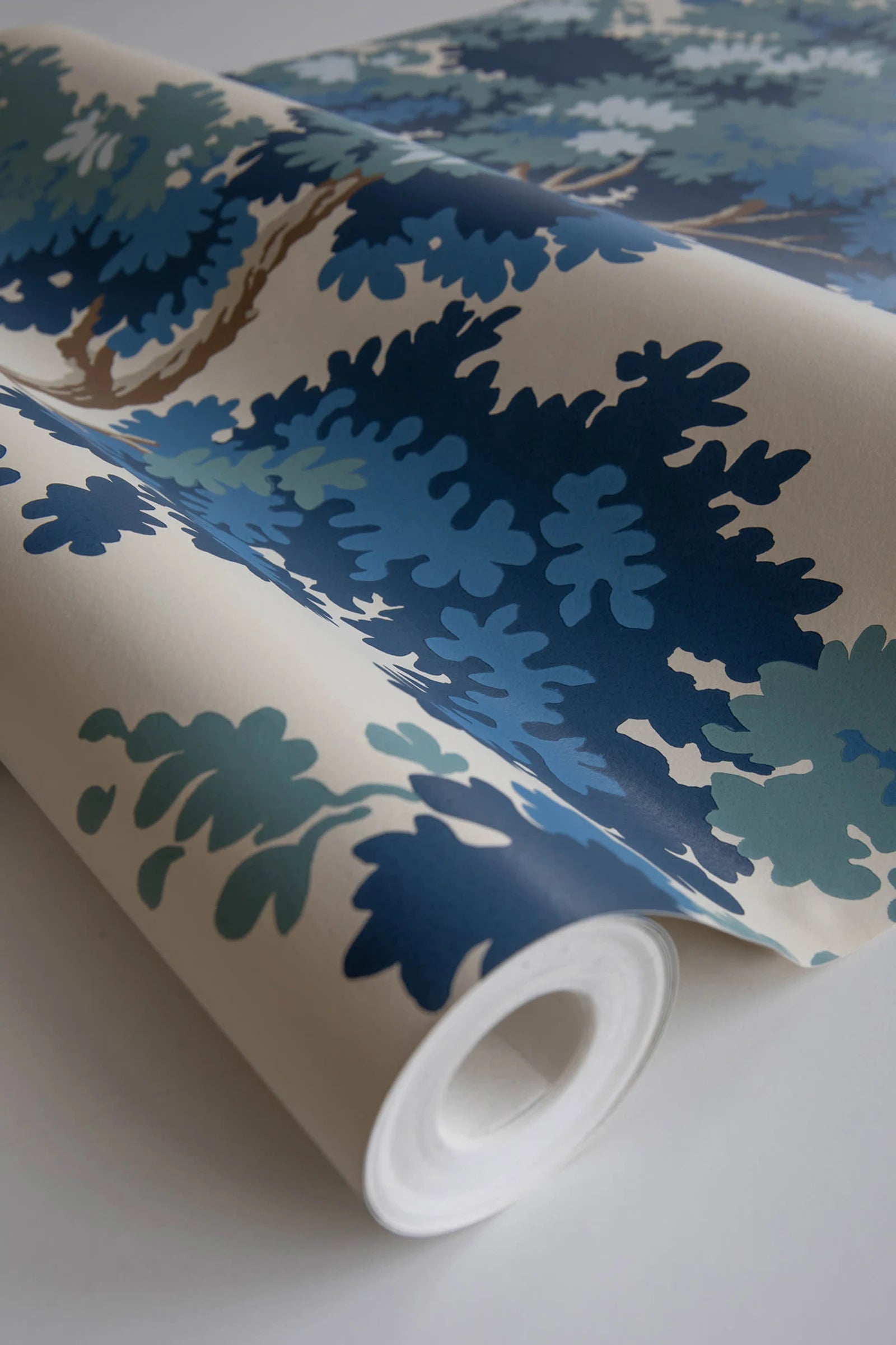Raphael wallpaper by Sandberg, close-up of a part-rolled roll in the blue and green oak-tree print