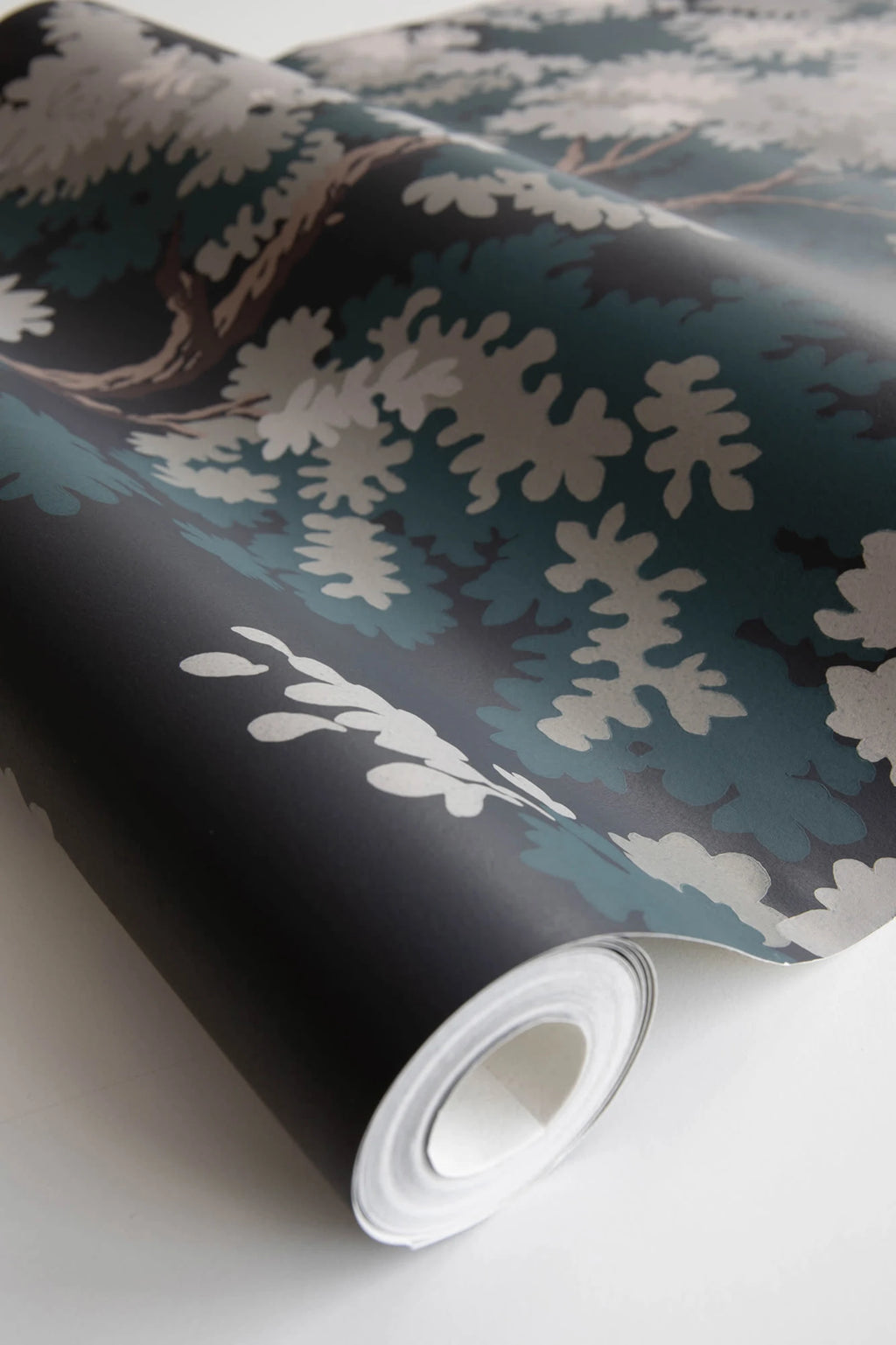 Raphael wallpaper by Sandberg, close-up of a part-rolled roll in the dark green and black oak-tree print